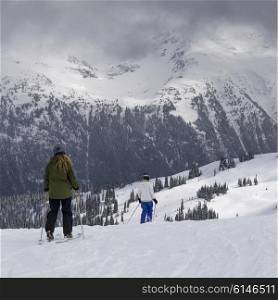 Tourists skiing on snow covered mountains, Whistler, British Columbia, Canada