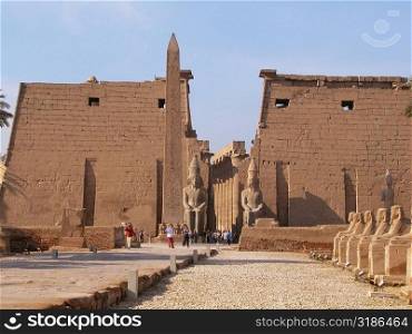 Tourists standing near a obelisk, Temple Of Luxor, Luxor, Egypt