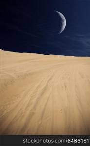 Tourists travel through the dunes in the Atacama Desert. Oasis of Huacachina, Peru, South America. moon shines