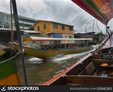 Tourists travelling on boat in canal, Bangkok, Thailand