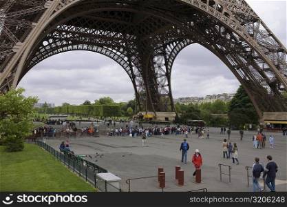 Tourists under a tower, Eiffel Tower, Paris, France