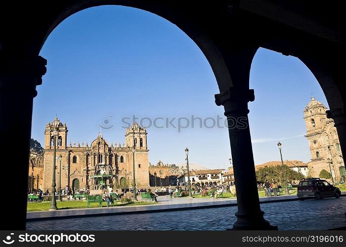 Tourists walking in front of a cathedral, Plaza-de-Armas, Cuzco, Peru