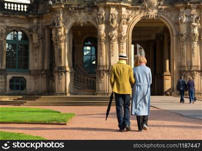Tourists walking near the ancient European building. Summer tourism and travels, famous europe landmark, popular places