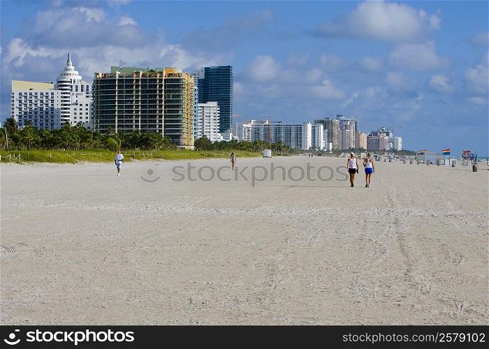 Tourists walking on the beach, South Beach, Miami Beach, Florida, USA