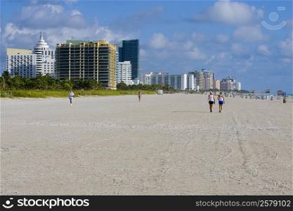 Tourists walking on the beach, South Beach, Miami Beach, Florida, USA