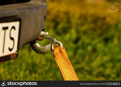 Tow hook with orange strap on car. Towing equipment. Tugging. Tow hook with orange strap on car. Towing equipment.