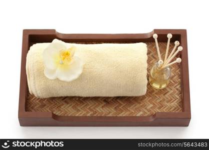 Towel and reed diffuser in a tray