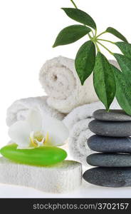 towel, green soap and stones on white