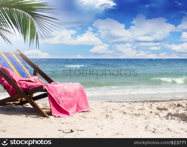 Towel on beach chairs at beautiful tropical beach