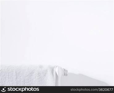 Towel on radiator and white wall