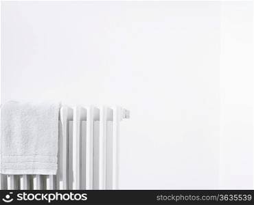Towel on radiator and white wall