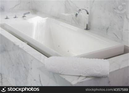 Towel on the ledge of a bathtub