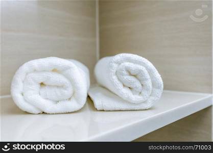 towel roll on bathroom shelf