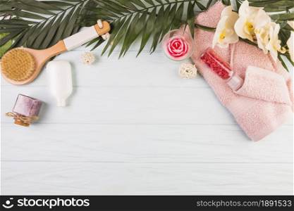towel salt bottle brush flowers leaves wooden background. Resolution and high quality beautiful photo. towel salt bottle brush flowers leaves wooden background. High quality and resolution beautiful photo concept