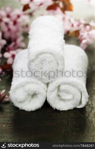 towels and spring cherry blossoms on wooden table