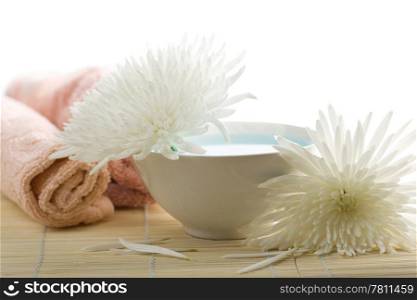 towels and white flowers isolated. spa and body care