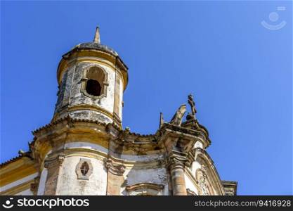 Tower and facade of a historic baroque church in the city of Ouro Preto in Minas Gerais. Tower and facade of a baroque church
