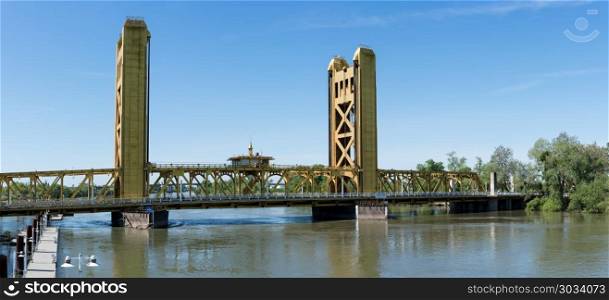 Tower Bridge Gateway across Sacramento River in California. Yellow drawbridge known as Tower Bridge Gateway across Sacramento river in Capital of California. Tower Bridge Gateway across Sacramento River in California
