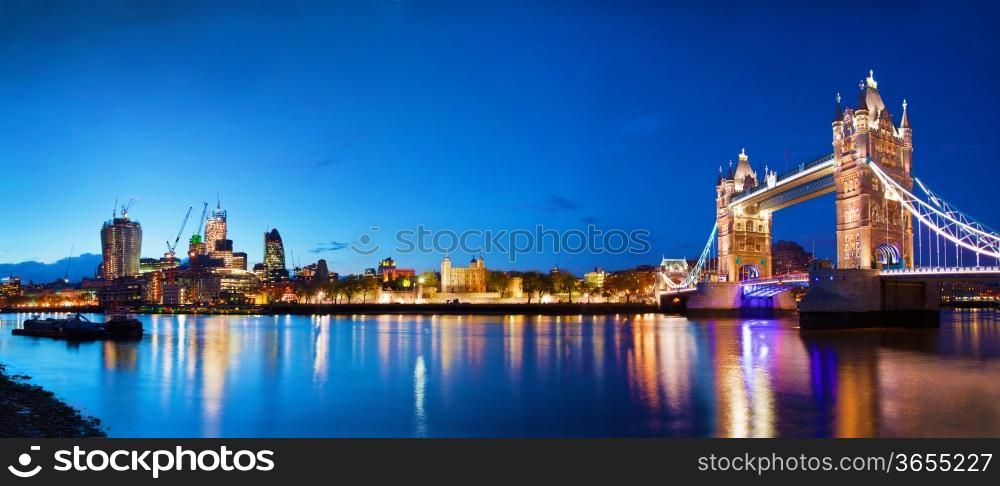 Tower Bridge in London, the UK at night. Panorama of the city centre