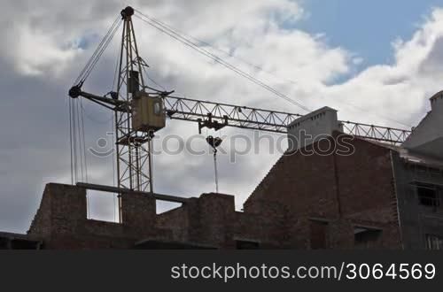 tower crane in construction building, sky before storm, time-lapse