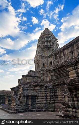 Tower in Angkor Wat temple with blue sky and clouds, Siem Reap, Cambodia
