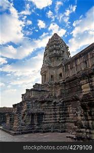 Tower in Angkor Wat temple with blue sky and clouds, Siem Reap, Cambodia