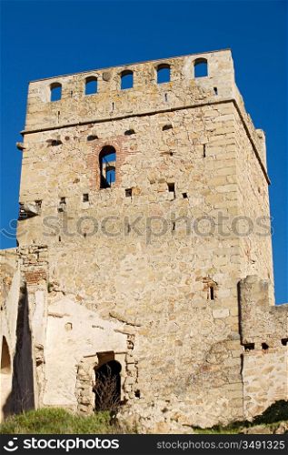tower of a castle in ruins on a blue sky