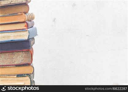 tower of books close up on white wooden background. set of books