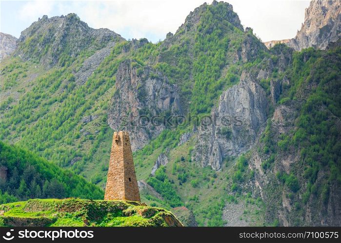Tower of Georgia on the background of the high mountains of the Caucasus
