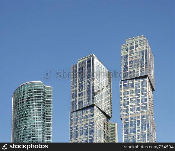 Tower on Embankment and Complex City of Capitals of Moscow International Business Center (Moscow-City) on blue sky background, Moscow, Russia