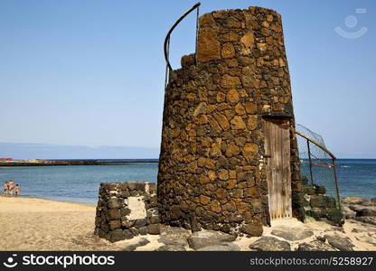 tower spain hill yellow beach black rocks in the lanzarote