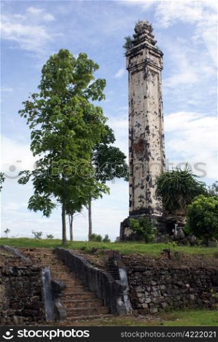 Tower, staircase and tree in royal complex near Hue, Vietnam