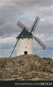 Tower windmill on pedestal of rock in Spain