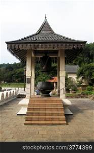 Tower with bronze bell in the inner yard of Tooth temple in Kandy, Sri Lanka
