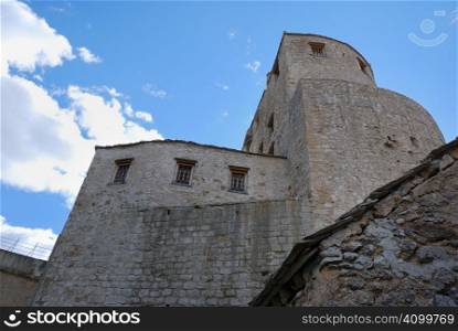 Towers in old town in Mostar, Bosnia and Herzegovina with blue sky in background.
