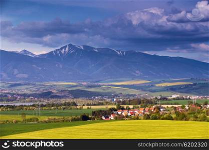 Town and green spring hills in Slovakia. May sunny countryside.