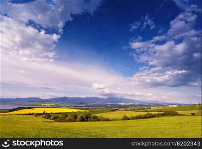 Town and green spring hills in Slovakia. May sunny countryside