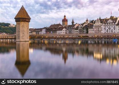 Town Hall, Water Tower, Wasserturm, and traditional frescoed building along the river Reuss at sunrise in Old Town of Lucerne, Switzerland. Lucerne at sunrise, Switzerland