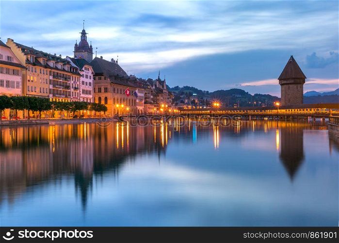 Town Hall, Water Tower, Wasserturm, and traditional frescoed building along the river Reuss at sunrise in Old Town of Lucerne, Switzerland. Lucerne at sunrise, Switzerland