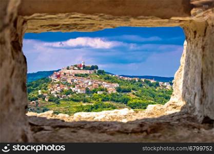 Town of Motovun on pictoresque hill of Istria through stone window, Croatia