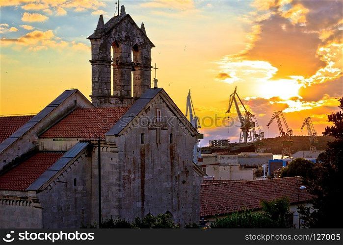 Town of Pula stone church and shipyard cranes sunset view, Istria region of Croatia