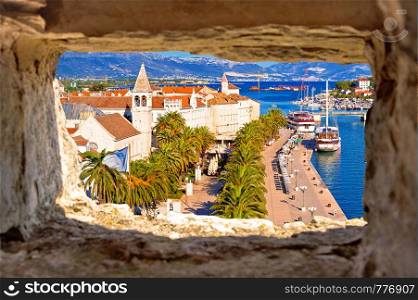 Town of Trogir waterfront and landmarks panoramic view through stone window, UNESCO world heritage site in Dalmatia region of Croatia