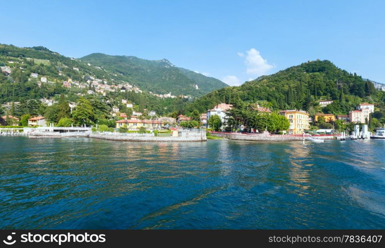 Town on Lake Como coast (Italy). Summer view from ship board