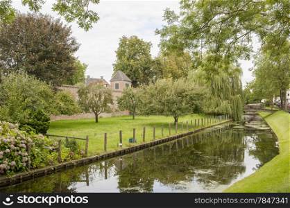 Town park with historic city wall, canal and trees at the city of Hattem, the Netherlands.