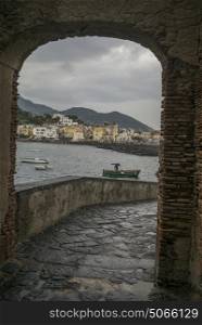 Town seen from causeway arch, Aragonese Castle, Ischia Island, Campania, Italy