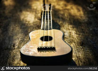 Toy acoustic guitar on vintage wood background, Close-up