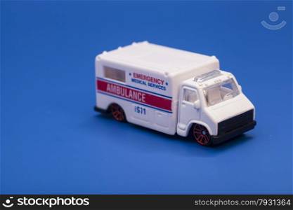 Toy ambulance car isolated on blue background