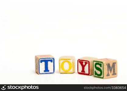 Toy blocks isolated on white spelling the word toys