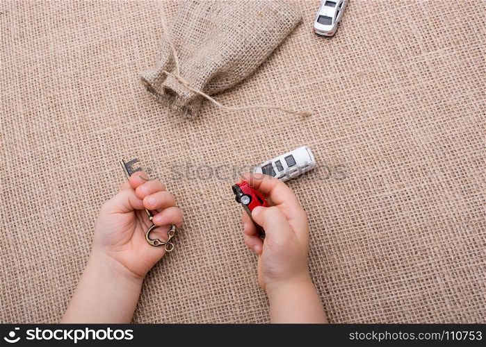 Toy car as a transportation devices in hand on a canvas background