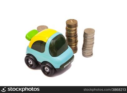 Toy car over a lot of coins isolated on white